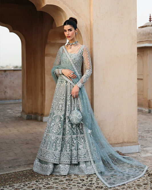 Dorien by Faiza Saqlain luxury mint blue bridal couture outfit front view featuring heavily hand-embellished net pishwas with intricate sequins, stones and resham embroidery in delicate floral heritage patterns, elegantly structured bodice with fitted sleeves and flowing flare silhouette, paired with richly embellished tissue lehenga featuring ornate embroidered borders and layered detailing, completed with heavily decorated net dupatta with all over sequin spray and four sided embroidered edging.