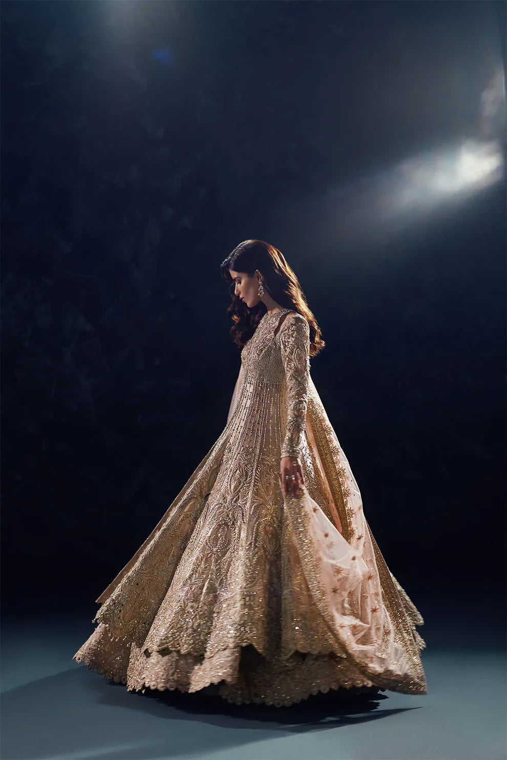 Reverie Soraya luxury gold tissue couture bridal gown front view featuring heavily hand-embellished upper bodice with intricate sheesha, dabka, naqshi and sequin embroidery in royal symmetrical pattern, structured flared silhouette with layered panels and flowing lehenga underlayer, richly detailed neckline and sleeves with fine hand embroidery, paired with heavily embroidered organza dupatta with sequins, dabka work and ornate border finishing, premium designer wedding outfit perfect for bridal wear.