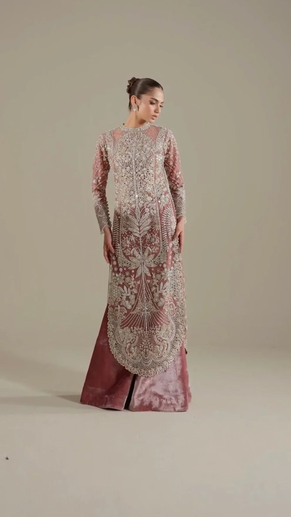 Velisse Soraya luxury dusty rose pink couture formal outfit front view featuring heavily hand-embellished organza shirt with intricate zari, naqshi, dabka, sequins and crystal embroidery arranged in royal symmetrical bridal pattern, richly detailed neckline and sleeves with fine resham work, paired with flowing lehenga/gharara in soft blush rose tone and heavily embroidered organza dupatta with scalloped borders, antique gold finishing and mukaish spray, premium designer wedding dress.