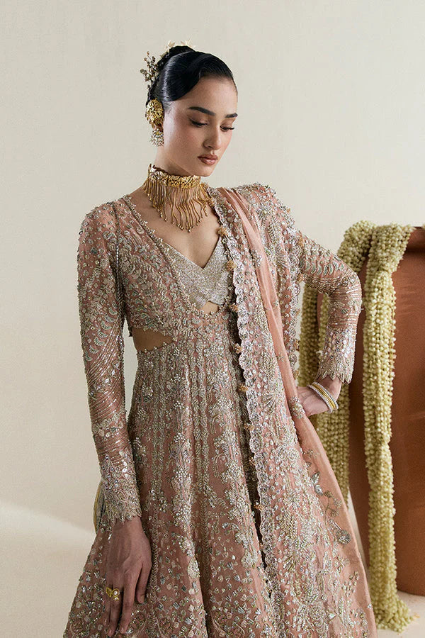 Suffuse Mahveen luxury bridal pishwas outfit front view featuring heavily hand-embellished tissue pishwas with fitted sleeves and layered bustier neckline, adorned with intricate mirror work, gota, resham and floral embroidery in sage green and gold accents, paired with richly panelled lehenga featuring ornate golden silver border detailing, completed with shikargah inspired tissue dupatta with geometric patterns, mirror work and four sided embroidered edges, premium Pakistani bridal couture 
