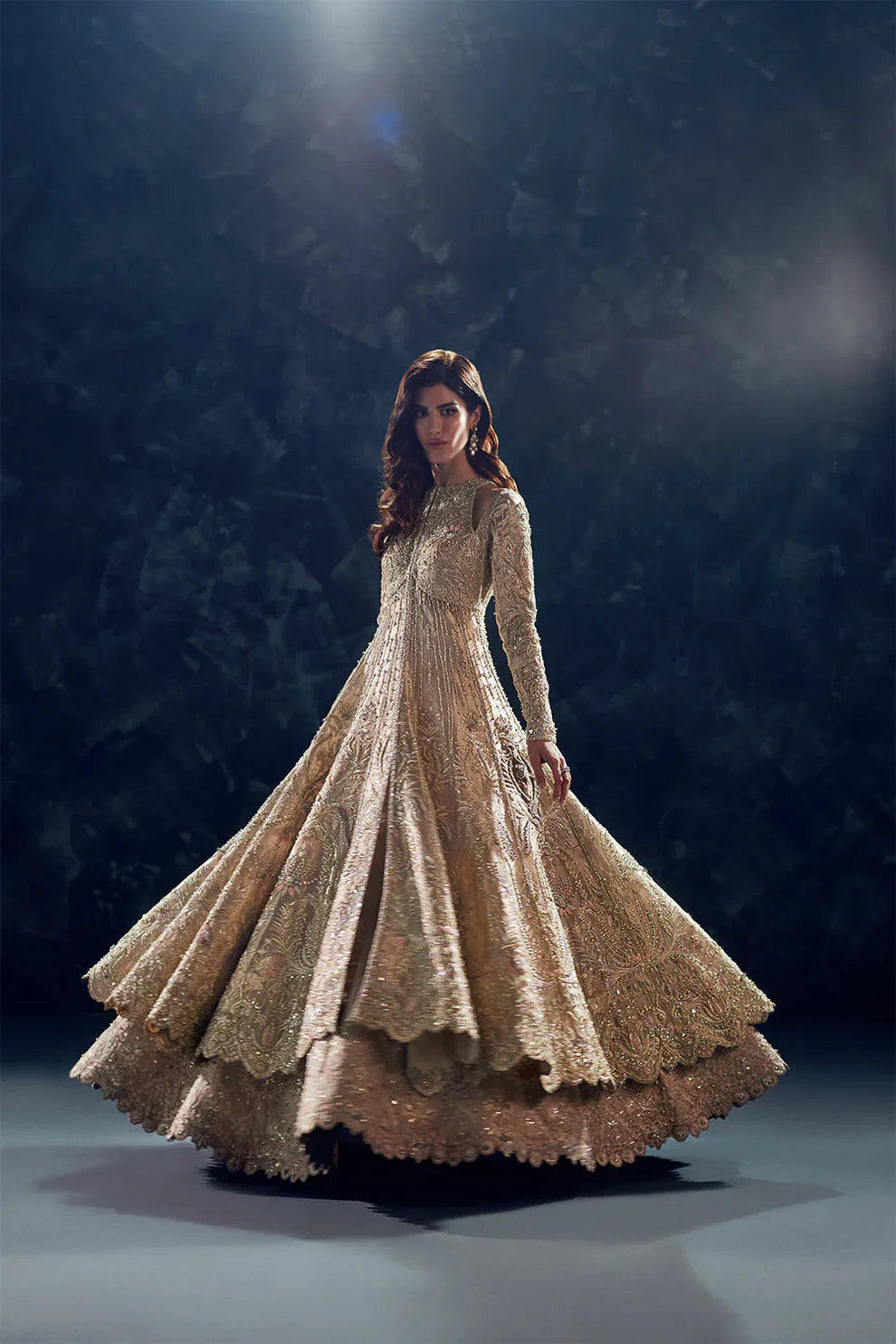 Reverie Soraya luxury gold tissue couture bridal gown front view featuring heavily hand-embellished upper bodice with intricate sheesha, dabka, naqshi and sequin embroidery in royal symmetrical pattern, structured flared silhouette with layered panels and flowing lehenga underlayer, richly detailed neckline and sleeves with fine hand embroidery, paired with heavily embroidered organza dupatta with sequins, dabka work and ornate border finishing, premium designer wedding outfit perfect for bridal wear.
