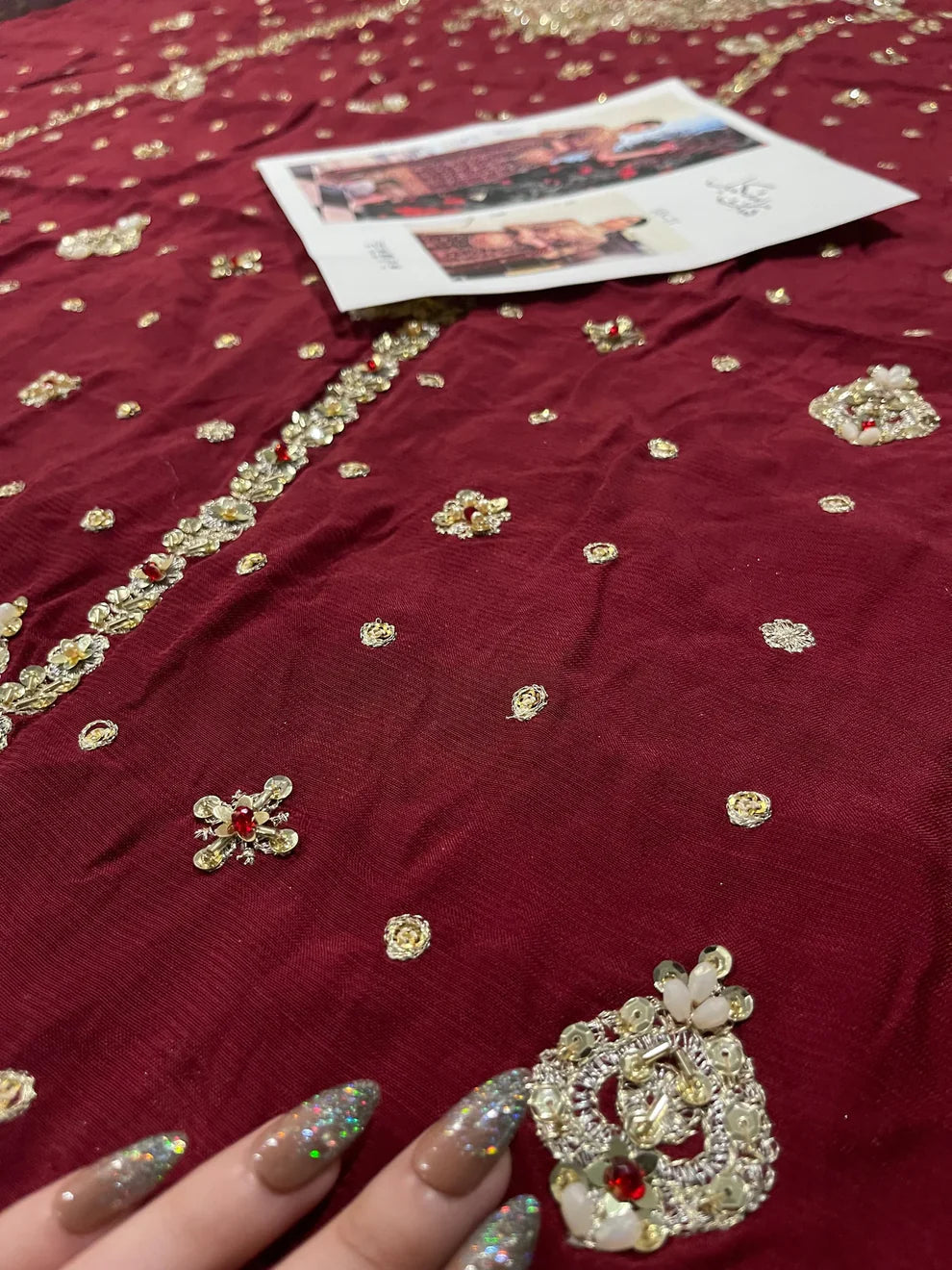 Libah by Haris Shakeel luxury formal outfit front view featuring deep maroon raw silk shirt with heavy all-over gold hand embroidery including intricate floral motifs, zari, resham and sequins work, elegant straight silhouette with richly decorated sleeves and ornate border finishing, paired with champagne toned straight trousers and sheer organza dupatta with subtle booti spray and detailed embroidered pallu, premium Pakistani designer outfit perfect for weddings, festive occasions, mehndi.