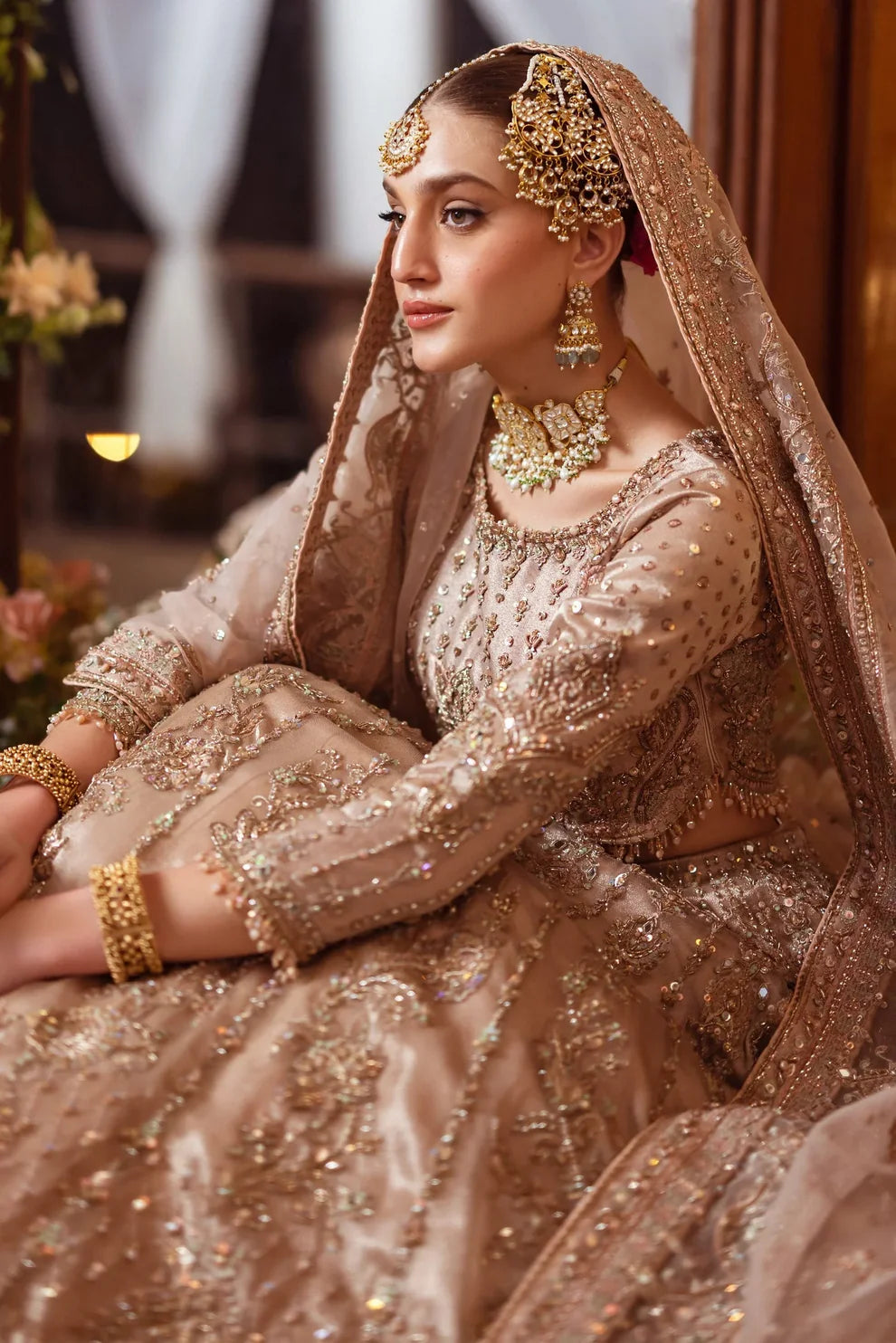 Naqshi Shabaab luxury formal couture outfit front view featuring heavily hand-embellished long shirt with intricate naqshi, dabka, kora, sitara, cutdana and crystal embroidery arranged in rich Mughal inspired floral and geometric patterns, detailed neckline and sleeves with full adda work, paired with matching embroidered trousers and heavily decorated dupatta with ornate borders, fine resham threadwork and shimmering sequin spray, premium Pakistani designer outfit perfect for weddings, festive occasions, m