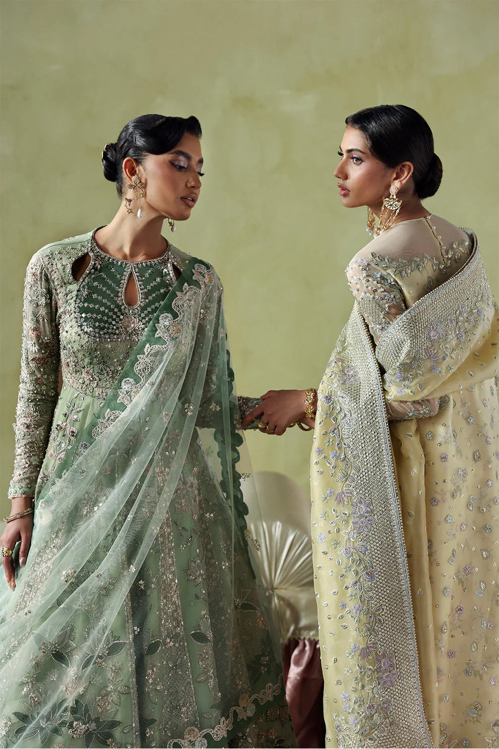 Lirien by Soraya luxury mint green couture pishwas outfit front view featuring heavily hand-embellished organza panels with intricate floral embroidery, resham threadwork, sequins, cutdana and tilla detailing arranged in elegant flowing pattern across flare, velvet accent neckline patch adding rich contrast, full embroidered sleeves and back panels, paired with lightweight net dupatta featuring embroidered sprays and delicate border finishing, along with dyed silk trouser, premium Pakistani designer outfit 