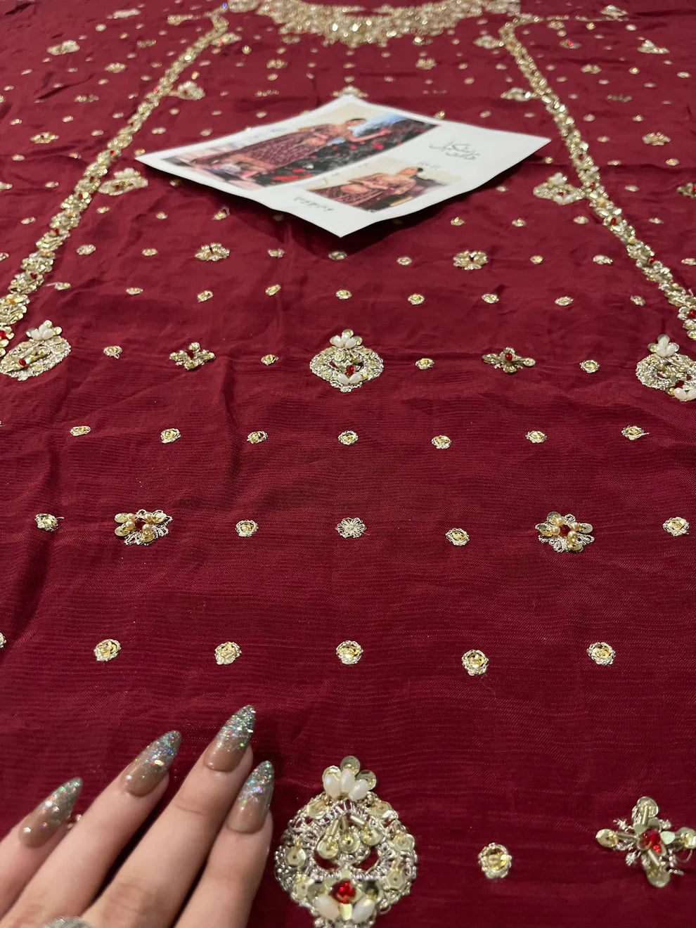 Libah by Haris Shakeel luxury formal outfit front view featuring deep maroon raw silk shirt with heavy all-over gold hand embroidery including intricate floral motifs, zari, resham and sequins work, elegant straight silhouette with richly decorated sleeves and ornate border finishing, paired with champagne toned straight trousers and sheer organza dupatta with subtle booti spray and detailed embroidered pallu, premium Pakistani designer outfit perfect for weddings, festive occasions, mehndi.
