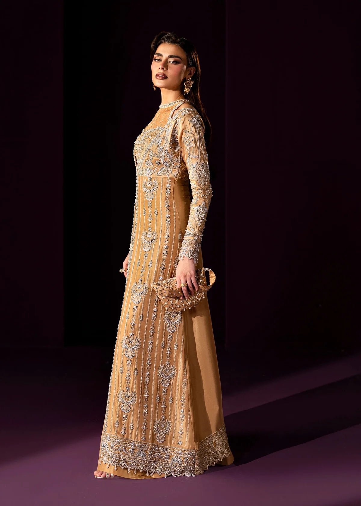 Oriana by Dastoor luxury couture formal outfit front view featuring nude gold tissue silk A-line gown with sheer halter bodice and structured neckline, heavily embellished with Swarovski crystals, pearls, sequins and fine hand embroidery arranged in elegant scattered constellation pattern, flowing silhouette with soft flare drape paired with matching palazzo pants in premium silk fabric, high-end designer outfit perfect for weddings, receptions, evening events and luxury formal occasions