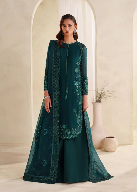 Eiza Dastoor luxury formal outfit front view featuring elegant ivory white raw silk shirt with heavy hand embroidery including intricate floral motifs, resham, sequins, kora and dabka embellishments arranged in refined symmetrical pattern, delicately detailed neckline and sleeve borders with fine craftsmanship, paired with matching straight trousers and soft organza dupatta with embroidered edges and light sequin spray, premium Pakistani designer outfit perfect for weddings, engagements, festive occasions 