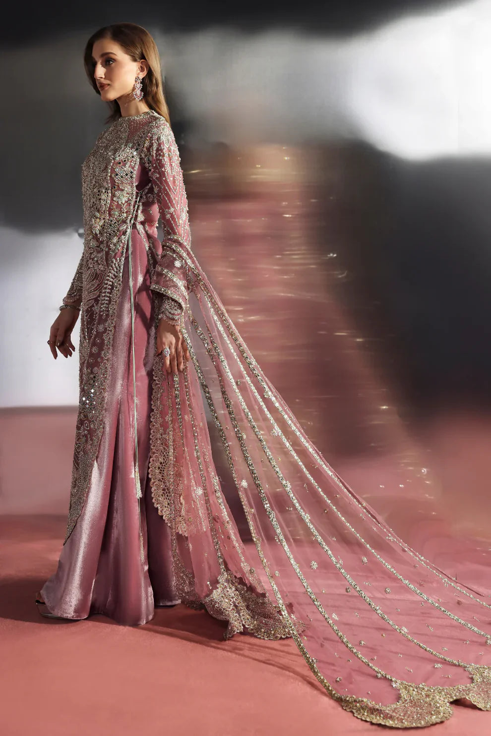 Velisse Soraya luxury dusty rose pink couture formal outfit front view featuring heavily hand-embellished organza shirt with intricate zari, naqshi, dabka, sequins and crystal embroidery arranged in royal symmetrical bridal pattern, richly detailed neckline and sleeves with fine resham work, paired with flowing lehenga/gharara in soft blush rose tone and heavily embroidered organza dupatta with scalloped borders, antique gold finishing and mukaish spray, premium designer wedding dress.