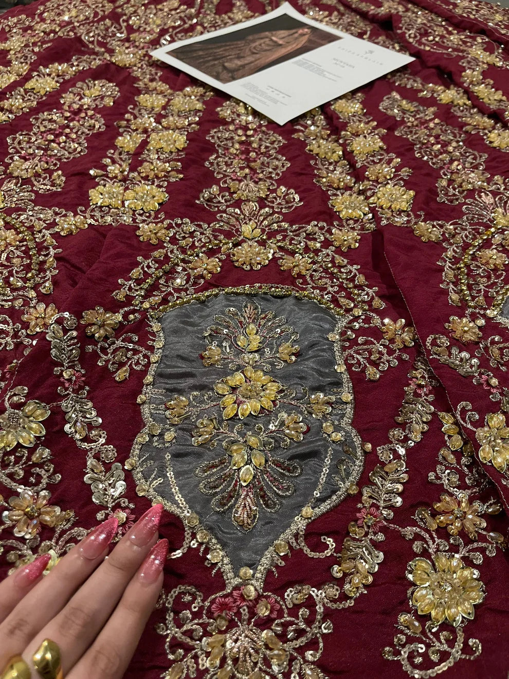 Faiza Saqlain Muntaha luxury bridal couture outfit front view featuring heavily hand-embellished raw silk shirt with intricate resham, dabka, naqshi and sequin embroidery in Mughal inspired floral motifs, paired with voluminous lehenga adorned with multiple richly embroidered borders and antique finishing, completed with a gracefully draped zari net dupatta with detailed adda work and ornate edging, premium bridal ensemble perfect for weddings, nikkah ceremonies and luxury festive occasions