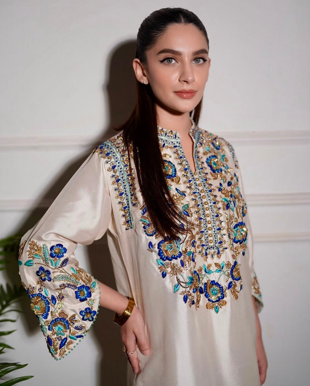 Elegant white designer embroidered suit with trousers
Premium Aleena Khan formal ensemble detailed embroidery close up
Aleena Khan white festive outfit full look for women