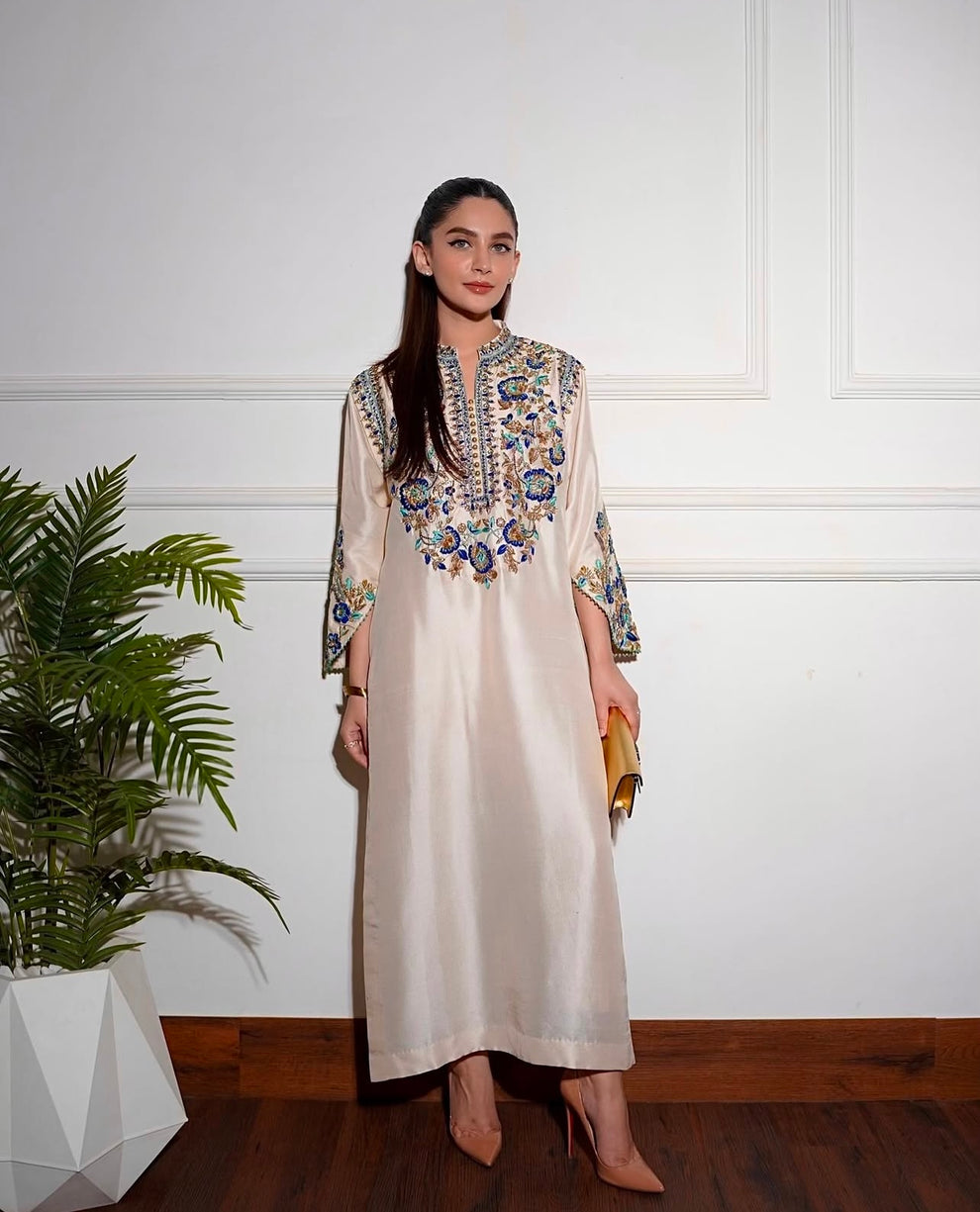 Elegant white designer embroidered suit with trousers
Premium Aleena Khan formal ensemble detailed embroidery close up
Aleena Khan white festive outfit full look for women