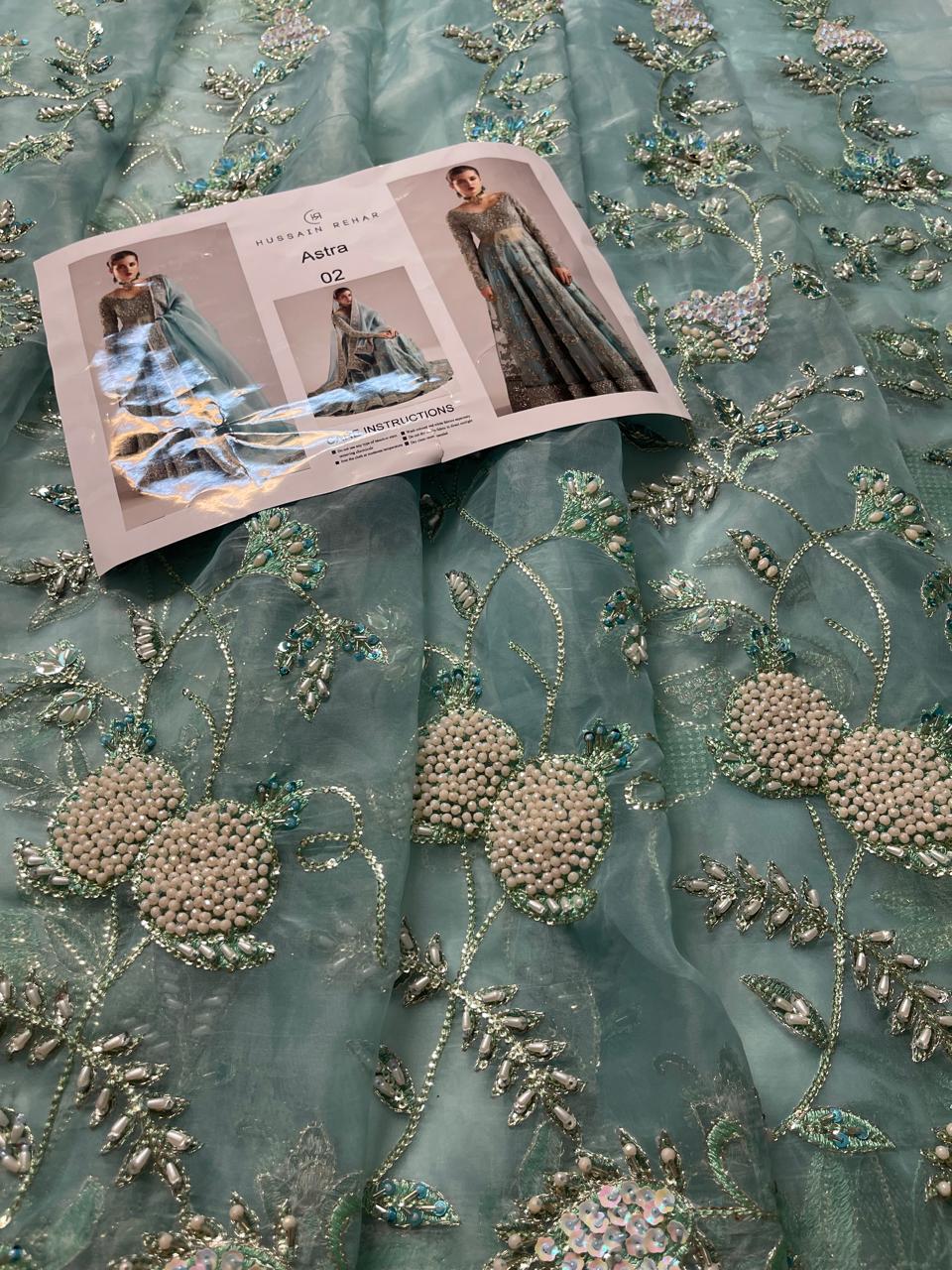 Close view of Astra unstitched bodice front showing heavy embroidery and embellishment work