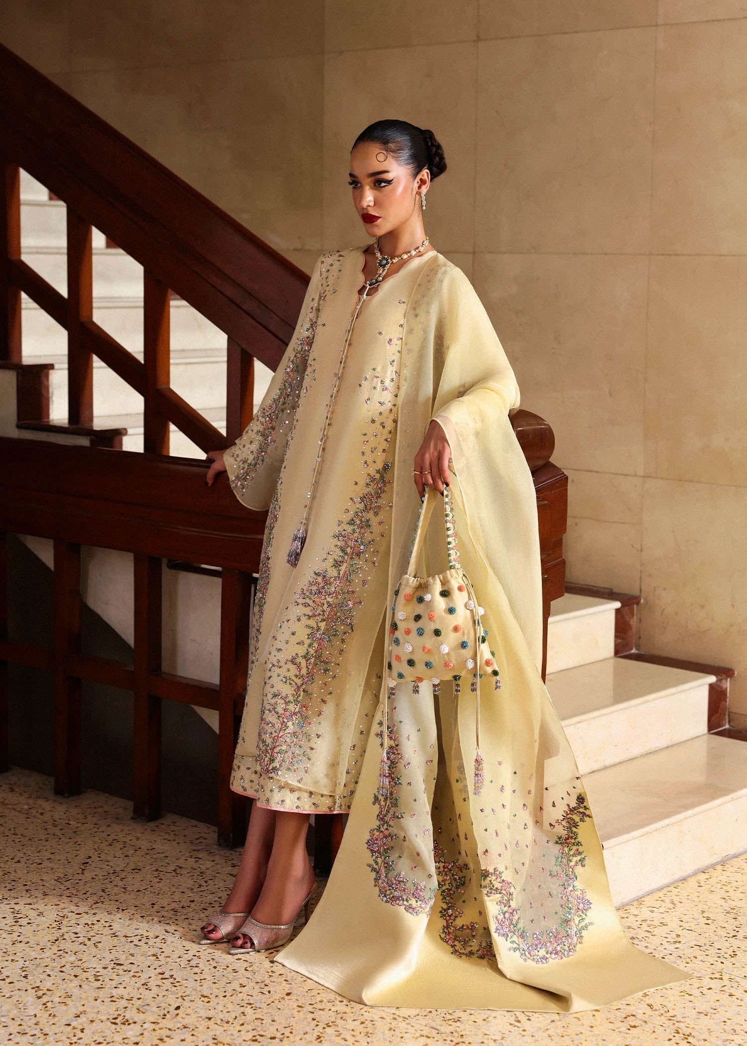 Left side view of butter yellow embroidered formal dress with soft silhouette