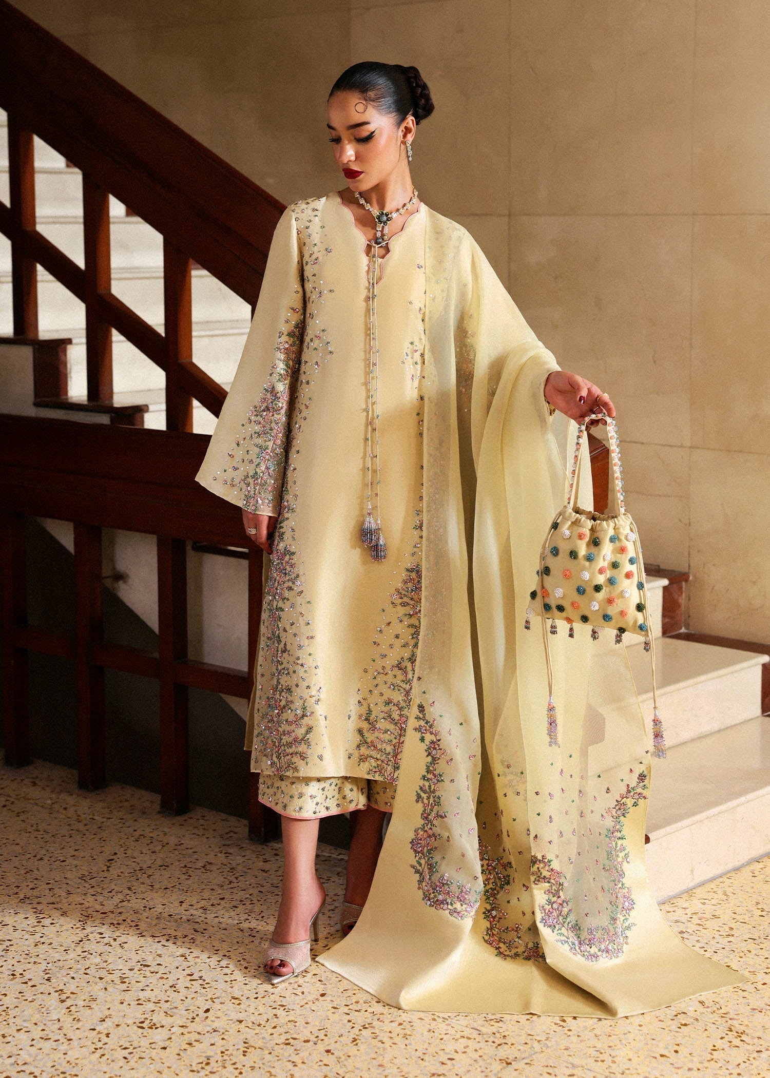 Front view of butter yellow embroidered Pakistani formal dress with organza dupatta
