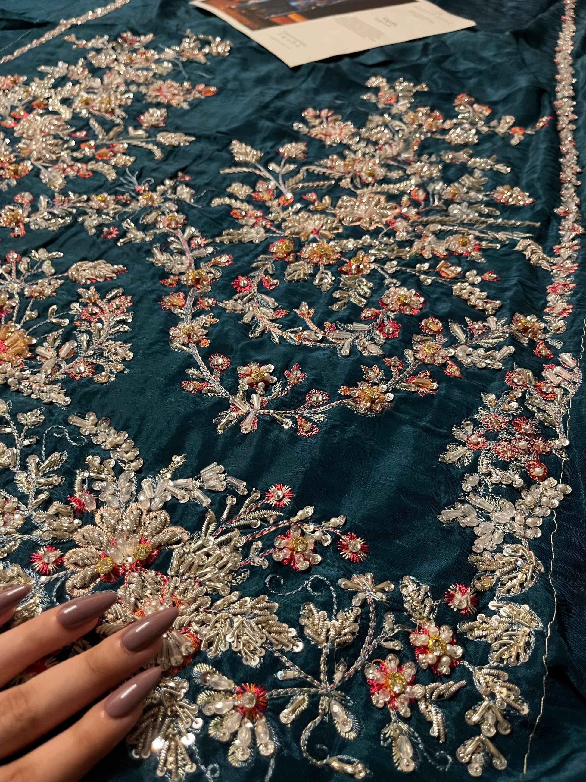 Detailed embroidery design on daaman of elegant teal green formal outfit
