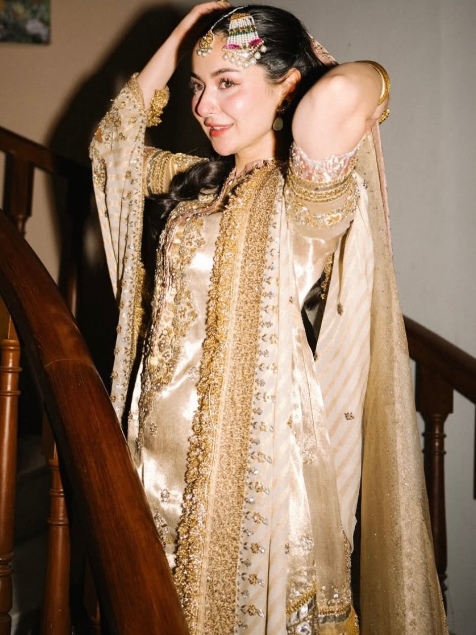 Side view of golden bridal formal dress with luxury embroidery and dupatta detailing