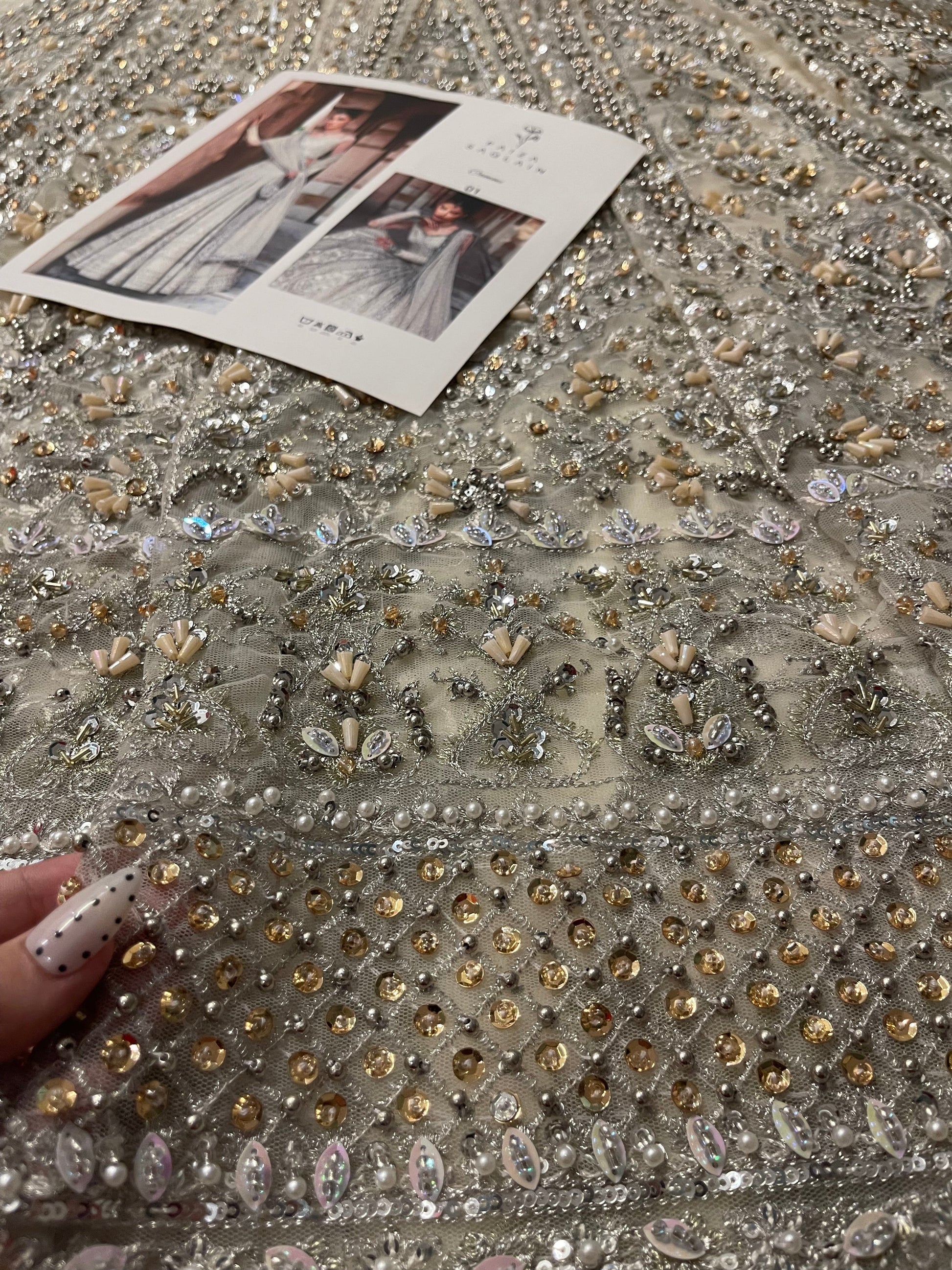 Closeup of Faiza Saqlain Cammi lehenga daman border with intricate resham tilla and crystal embroidery on white net