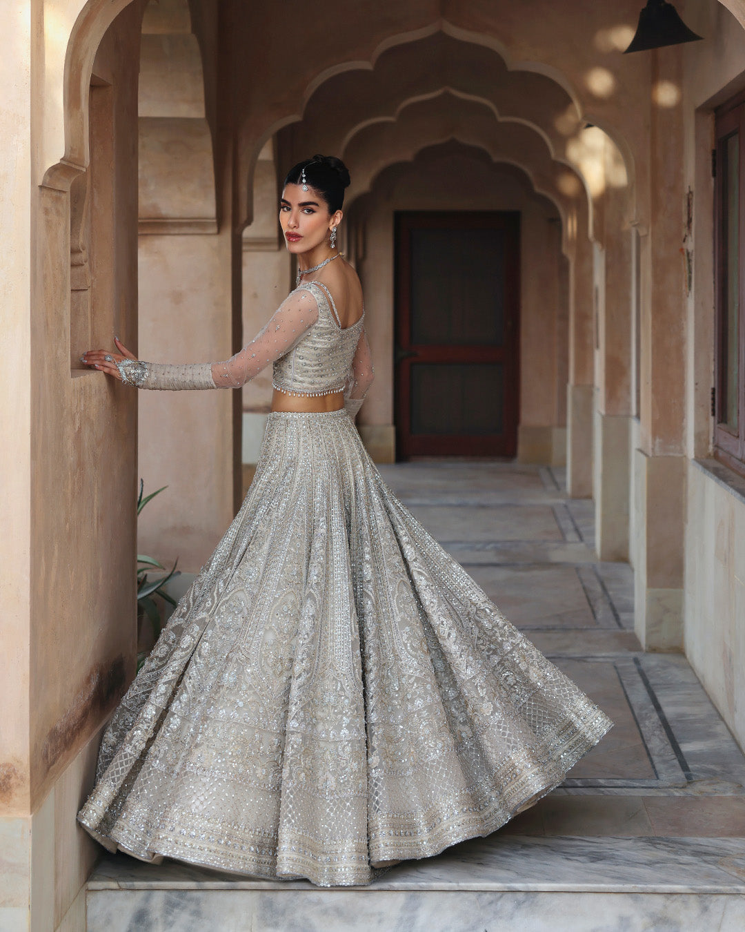 Side view of Faiza Saqlain Cammi white bridal lehenga choli with elegant silhouette