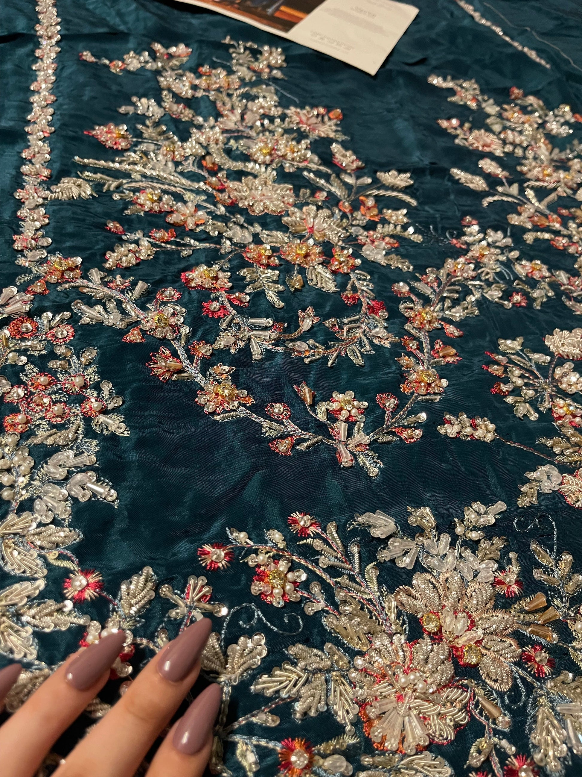 Floral embroidery close view on daaman of teal green Pakistani dress
