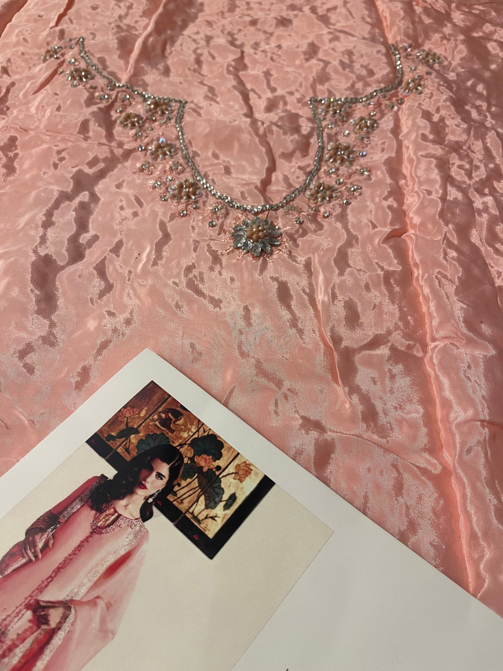 Closeup of Hussain Rehar Evara neckline featuring intricate floral embroidery and sequin embellishments on blush pink fabric