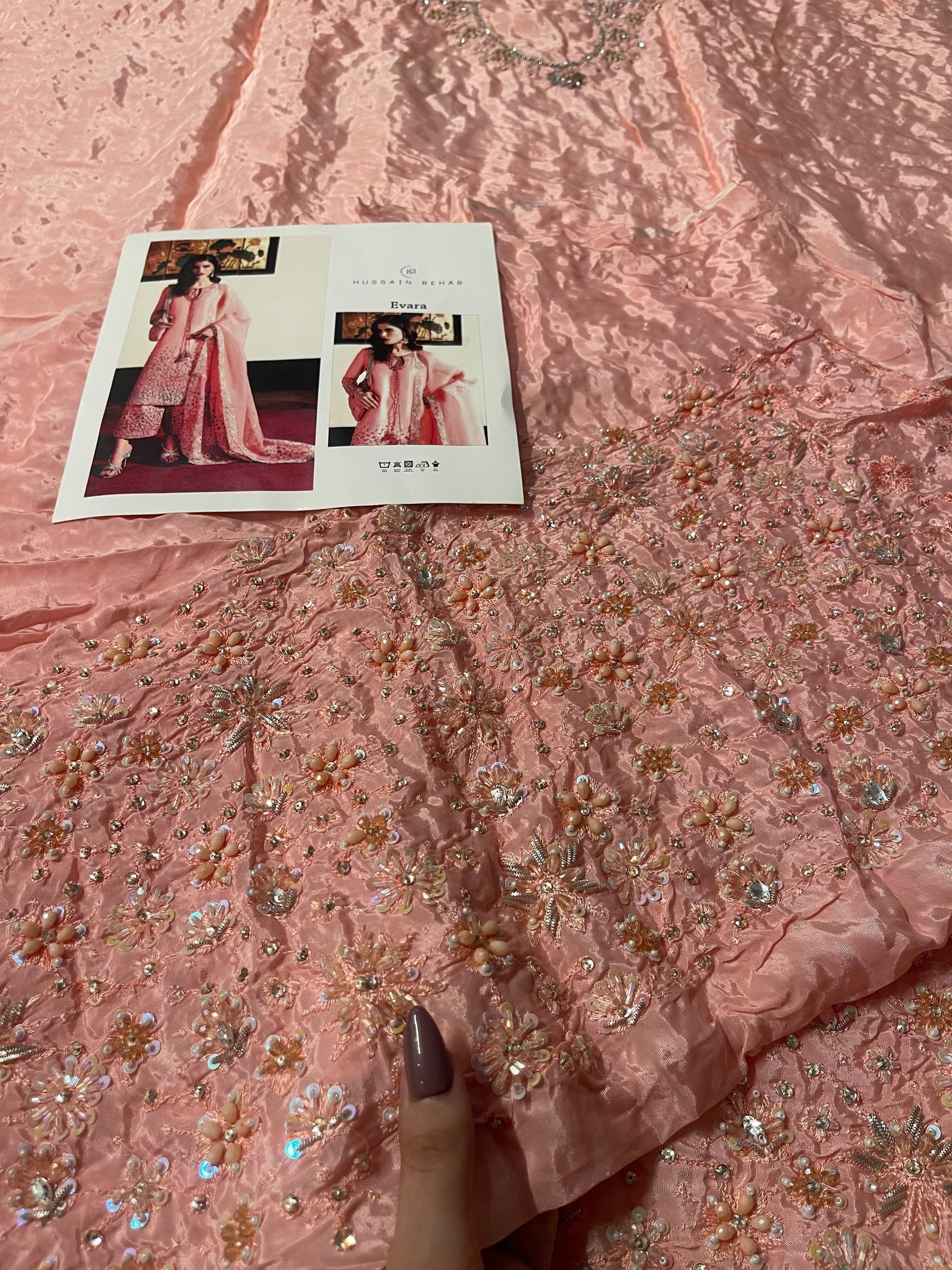 Closeup of Hussain Rehar Evara unstitched dress material highlighting detailed embroidery on raw silk fabric