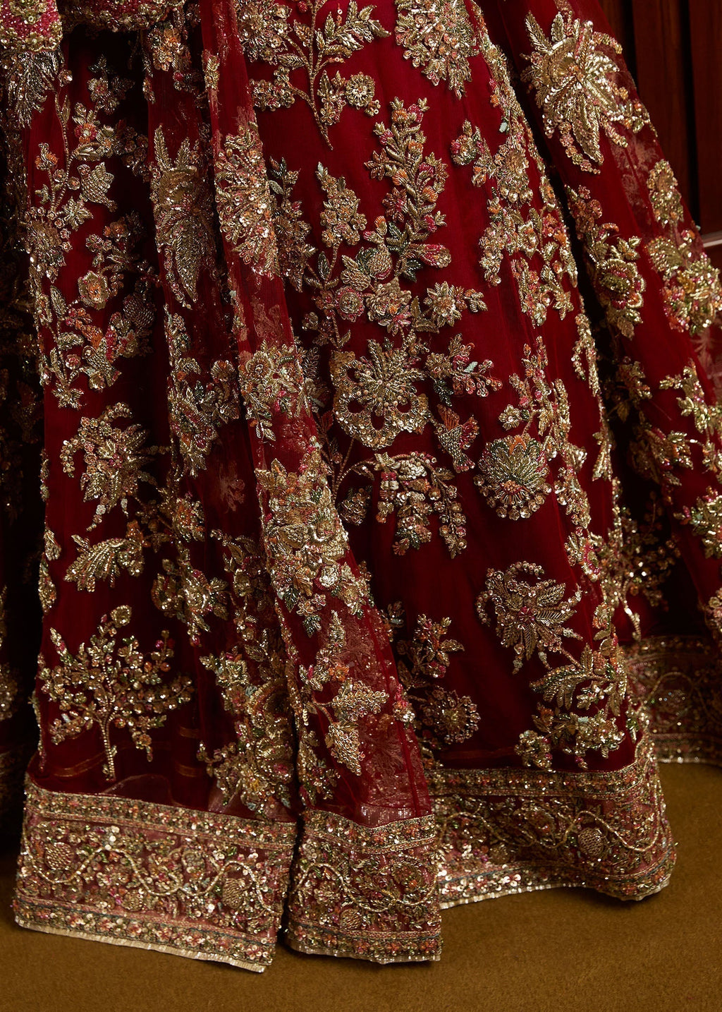 Closeup view of Hussain Rehar Qashqaye lehenga showing detailed gotta tilla cut dana and sequin embroidery on satin silk