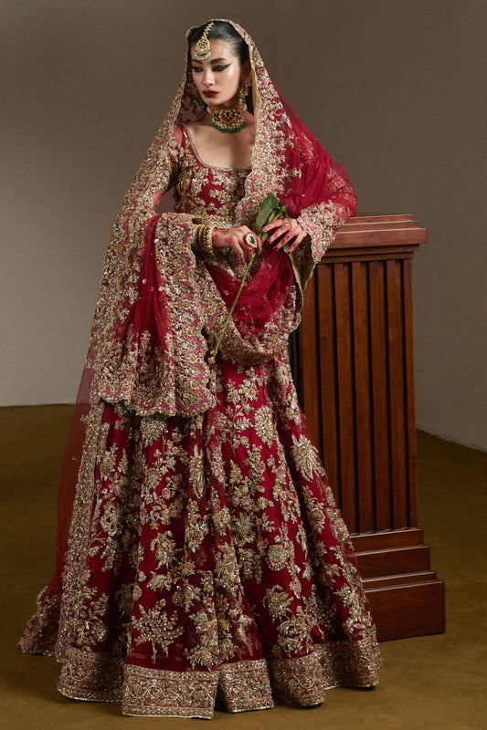Woman wearing Hussain Rehar Qashqaye ruby bridal pishwas lehenga front full view