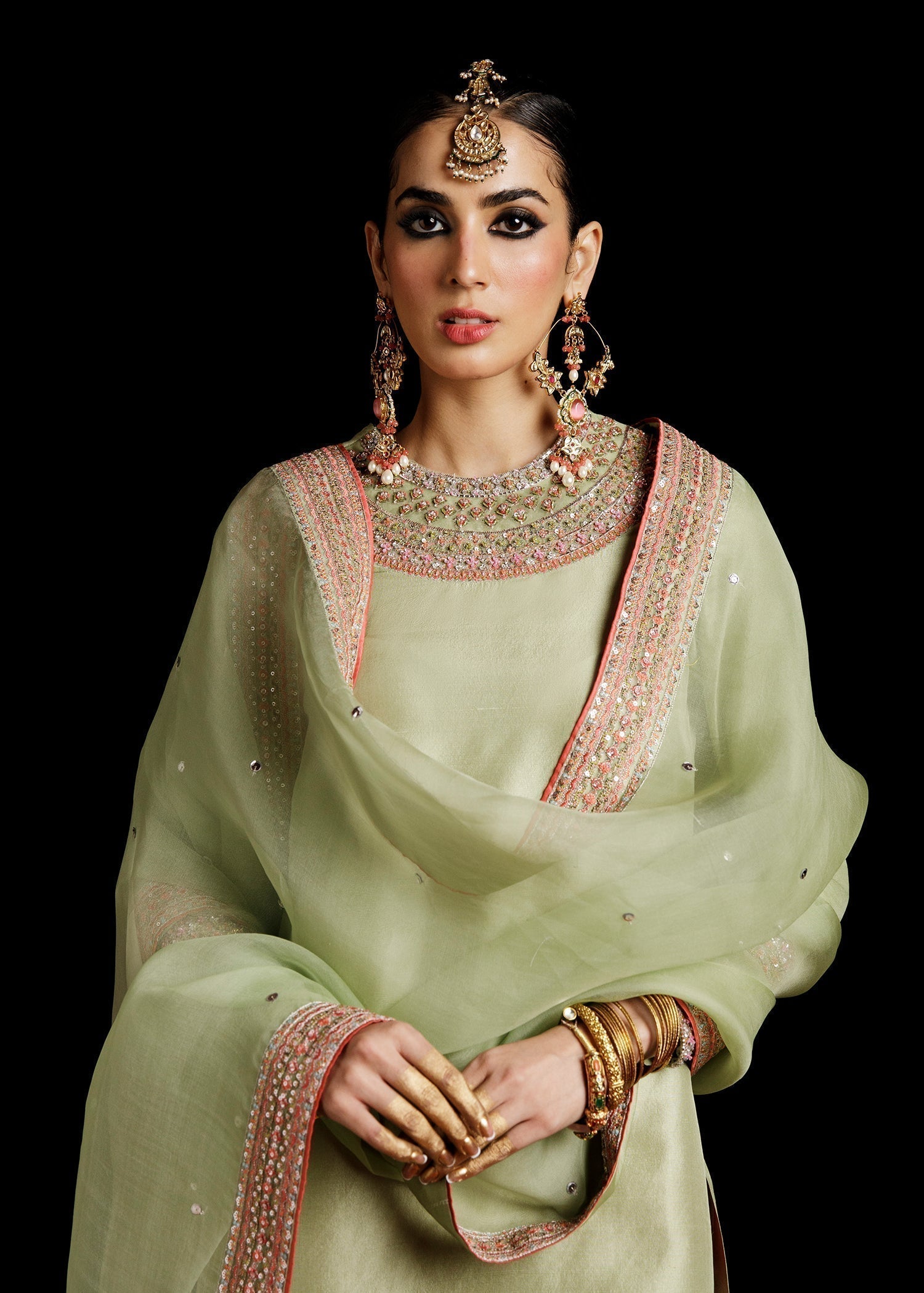 Close view of pistachio green embroidered Pakistani dress with detailed craftsmanship