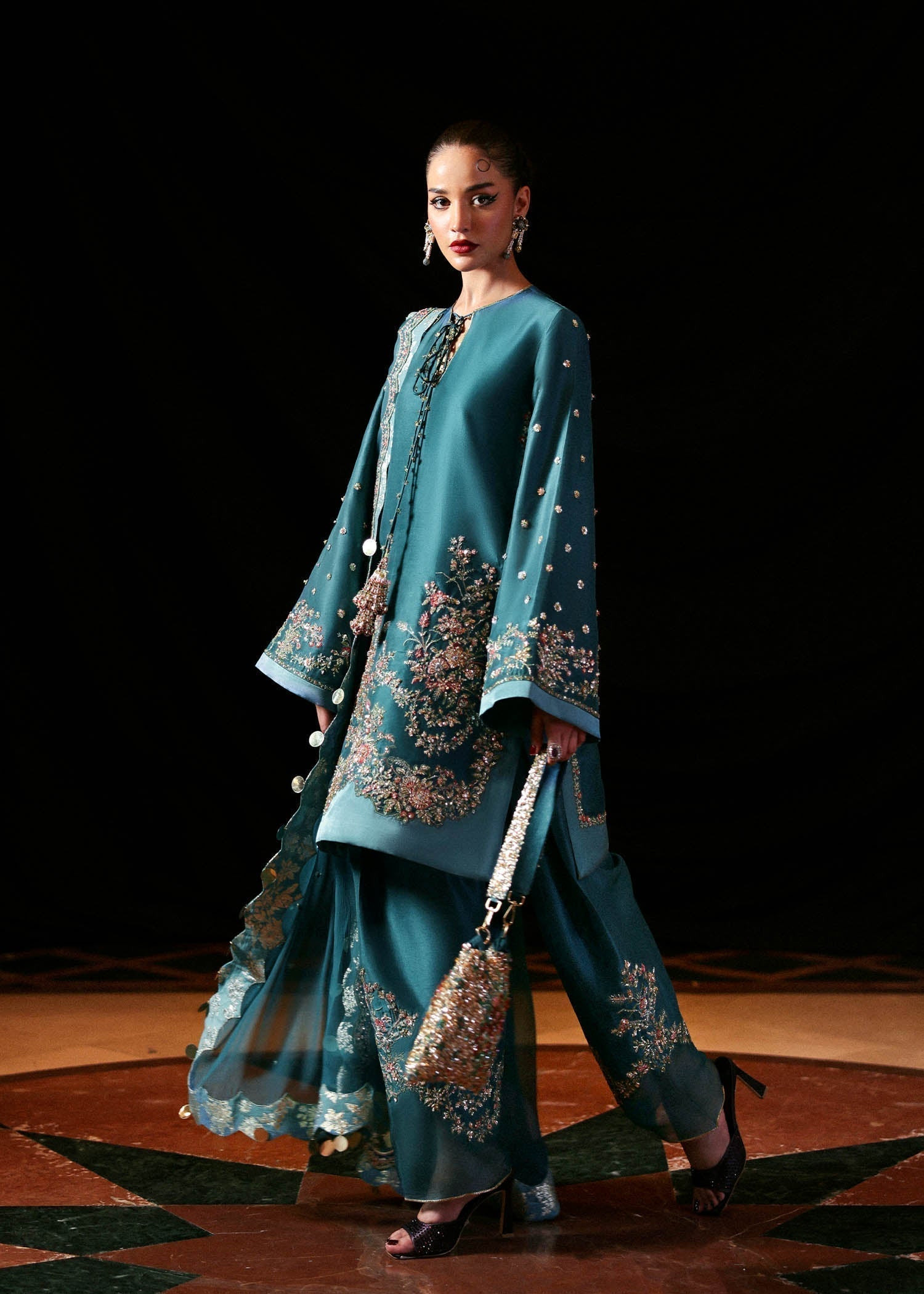 Luxury Hussain Rehar Verta outfit detailed embroidery close up
Elegant teal green embroidered formal ensemble full look