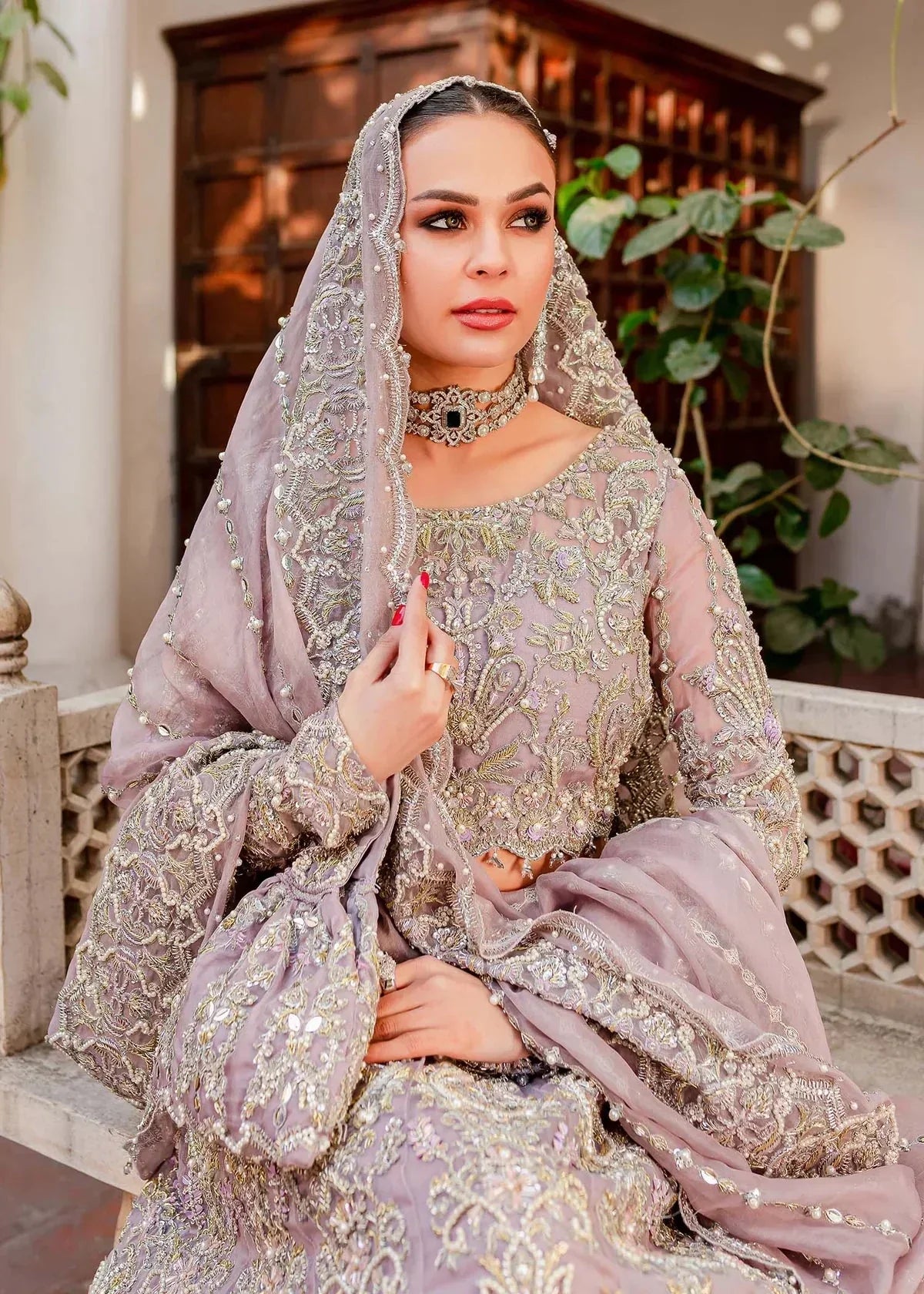 Full view of intricate hand embroidery on Zaarish Kanwal Malik lilac bridal lehenga with naqshi dabka crystals
